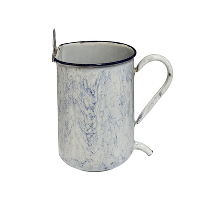 A vintage-style enamel mug with a white and blue marbled pattern, a dark blue rim, and a metal loop handle on a plain white background.