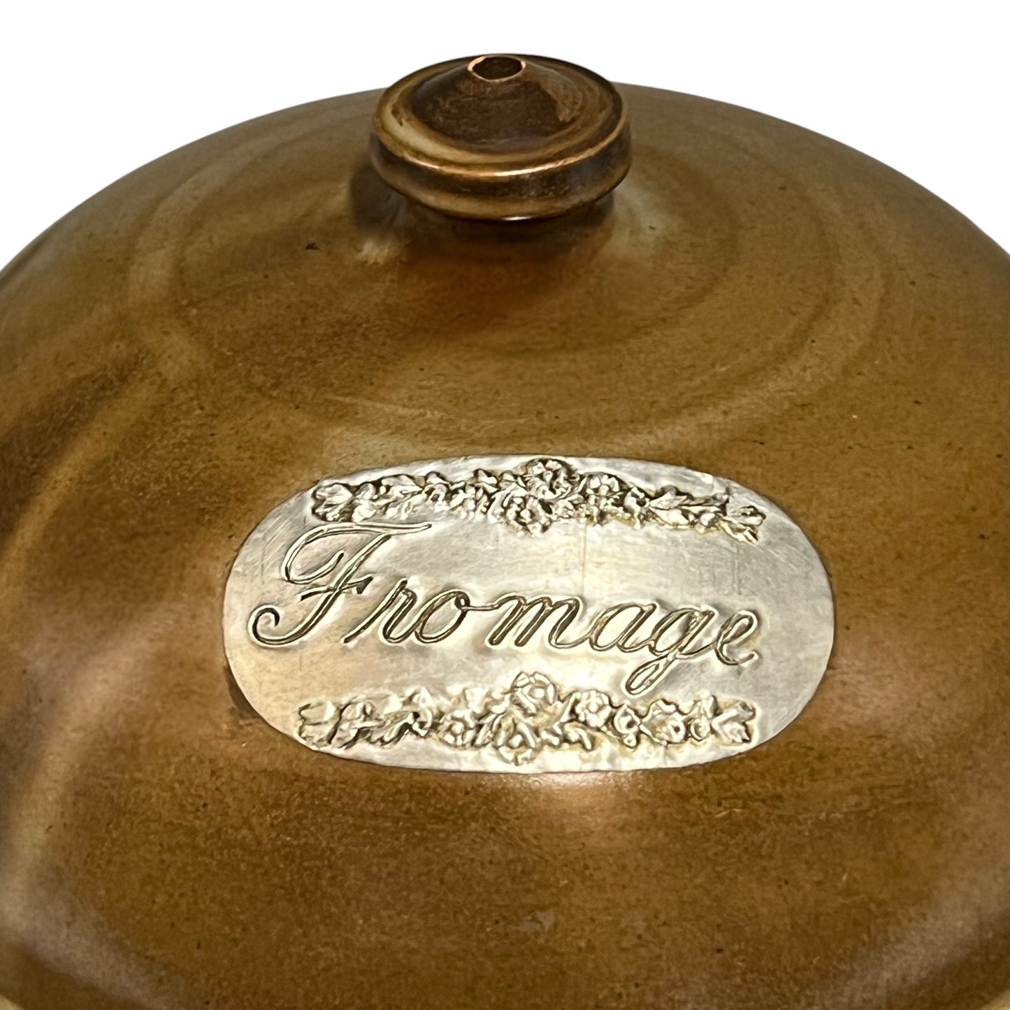 Brown ceramic cheese cloche with 'Fromage' label on a white background