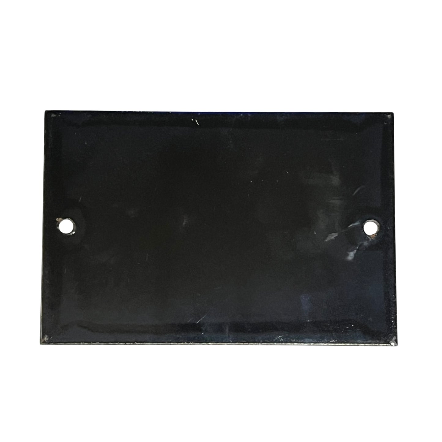 Rectangular black metal plate with two holes on a white background