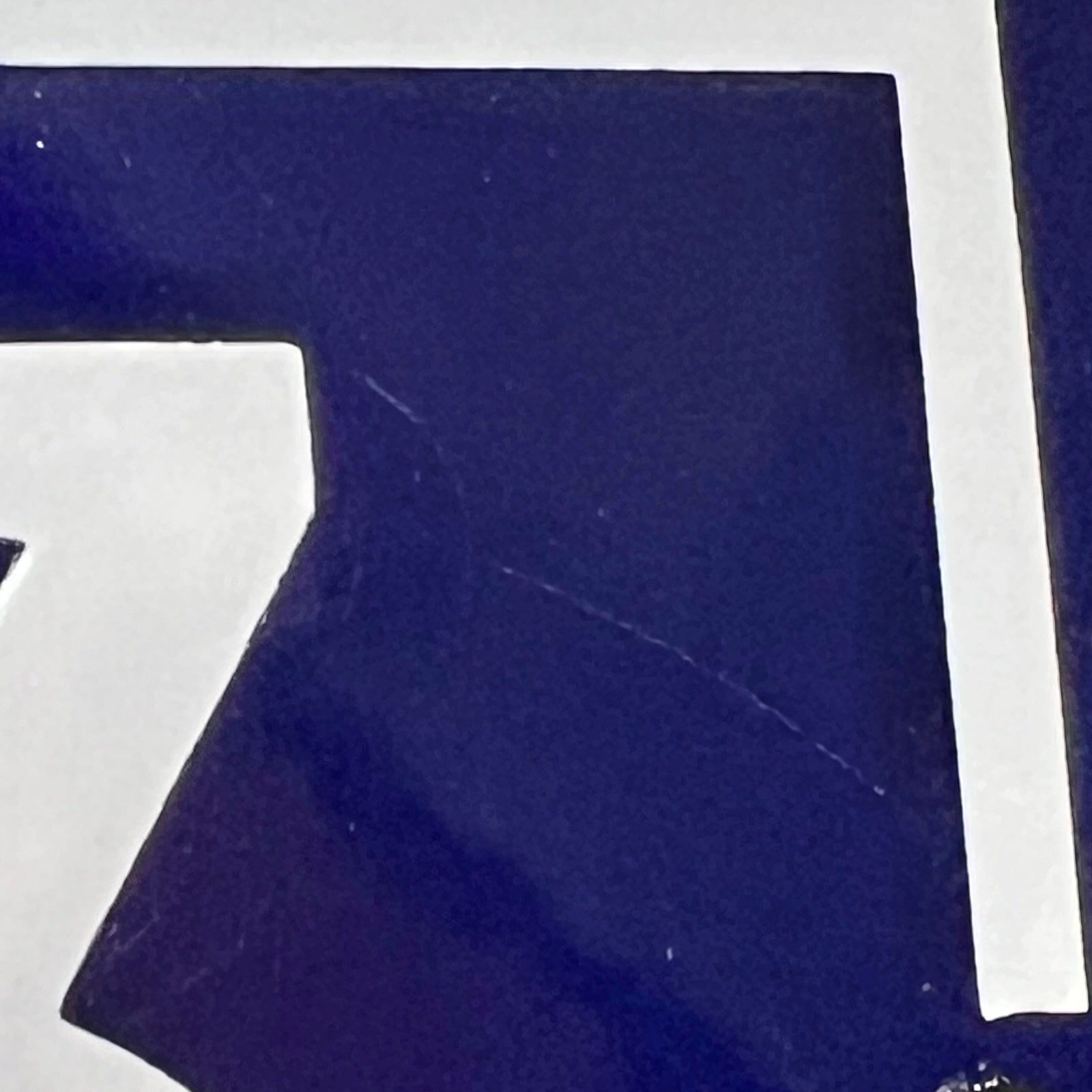 close up of a french blue door sign with white number '43' on a white background