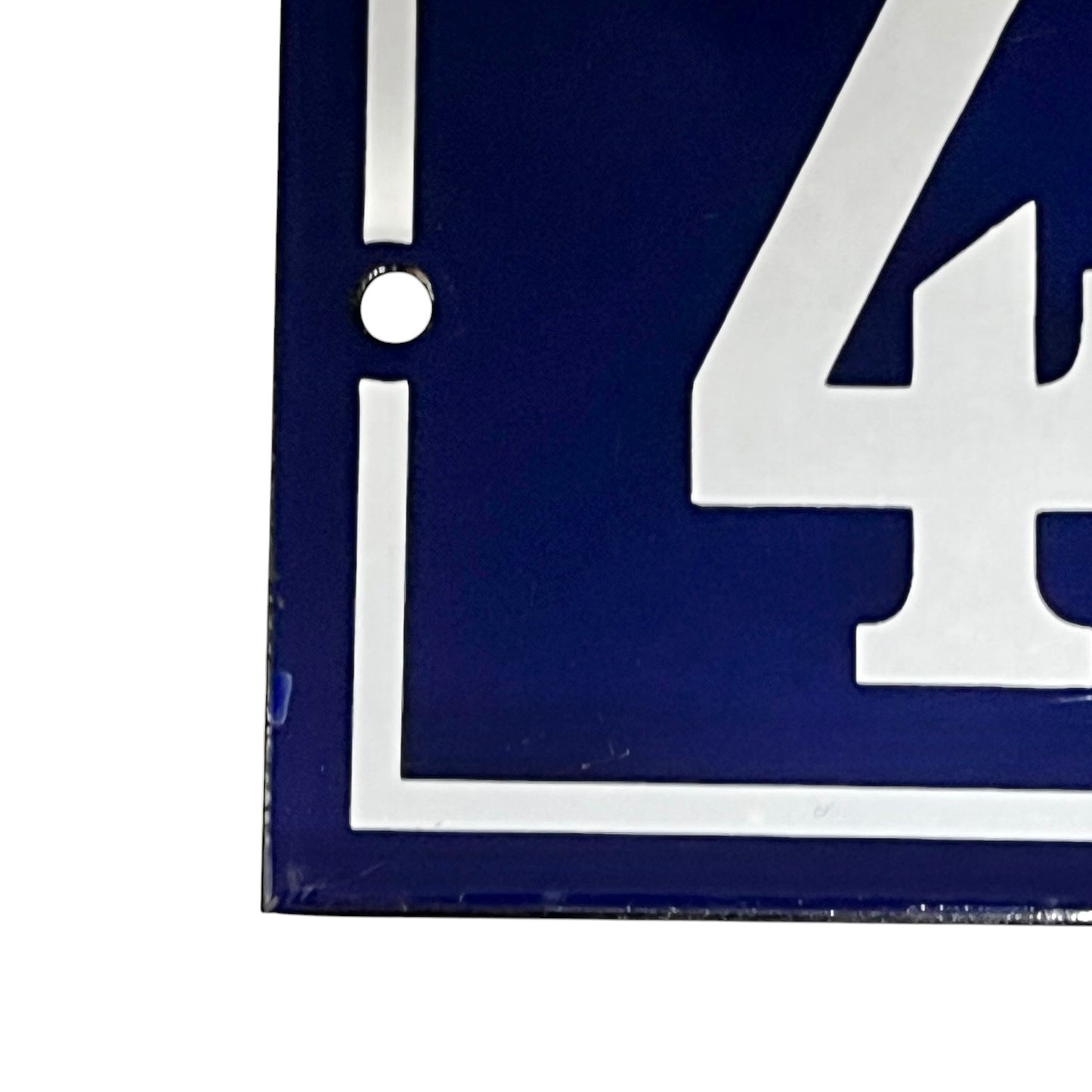 close up of a french blue door sign with white number '43' on a white background