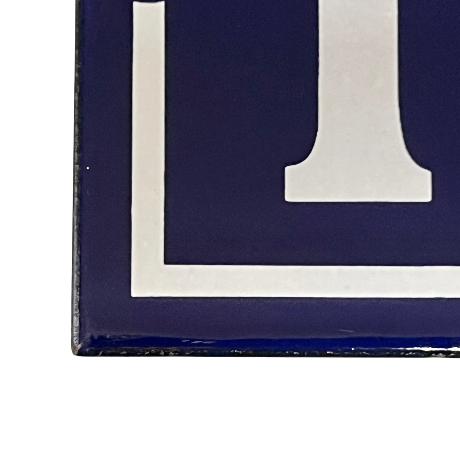 Close-up of a blue and white enamel door number 195
