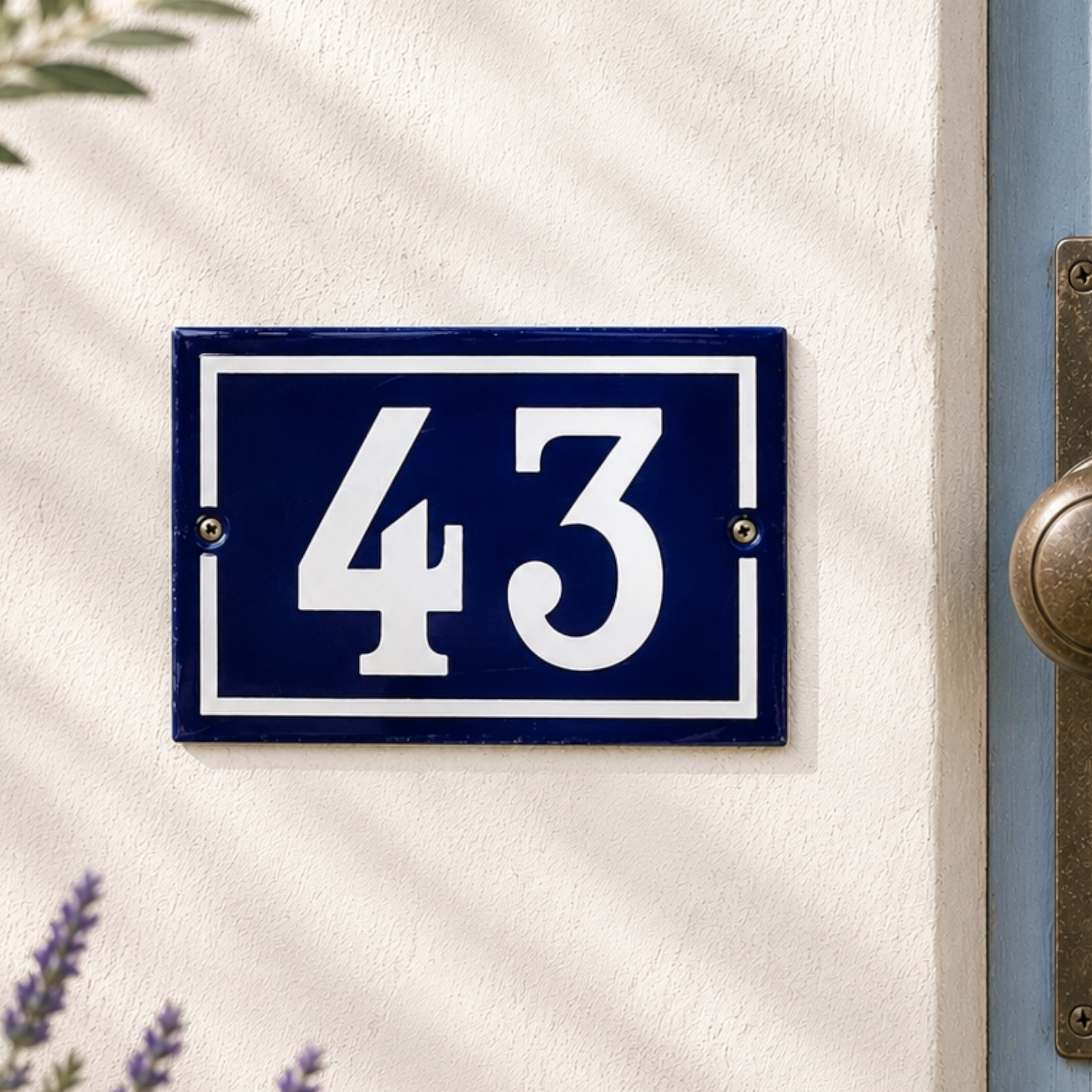 Blue house number plate with '43' on a white door
