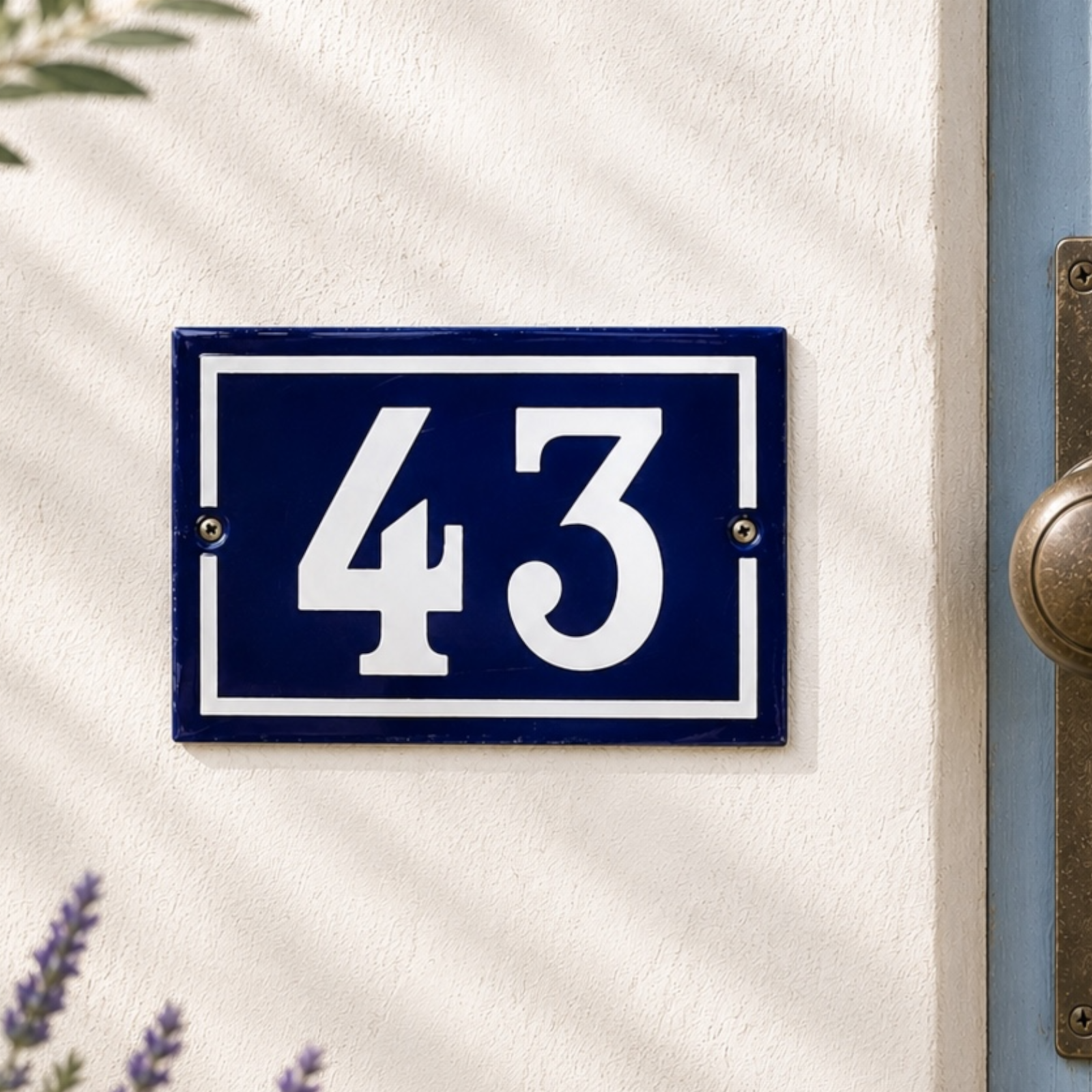Blue house number plate with '43' on a white door