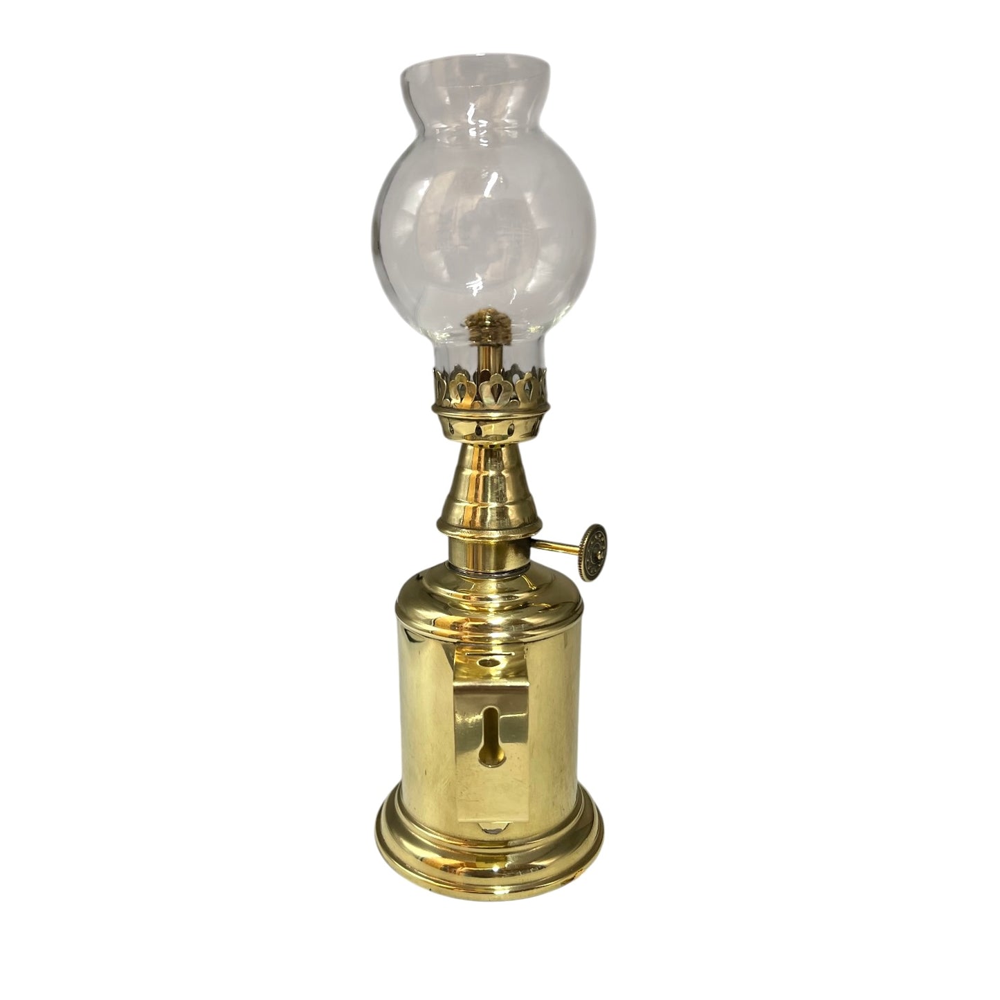 Vintage brass oil lamp with clear glass shade on a white background