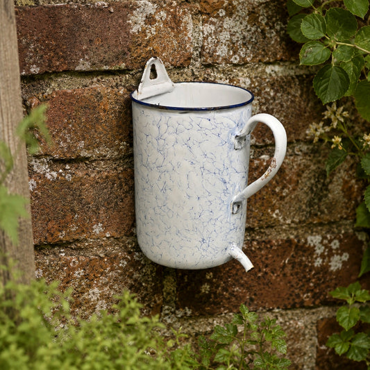 French enamel vintage garden wall mounted planter or kitchen bathroom storage pot, ideal for a rustic country cottage on a stone rustic  wall