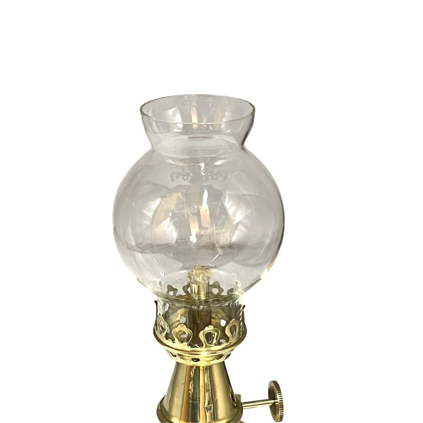 Vintage-style oil lamp with clear glass shade and brass base on a white background