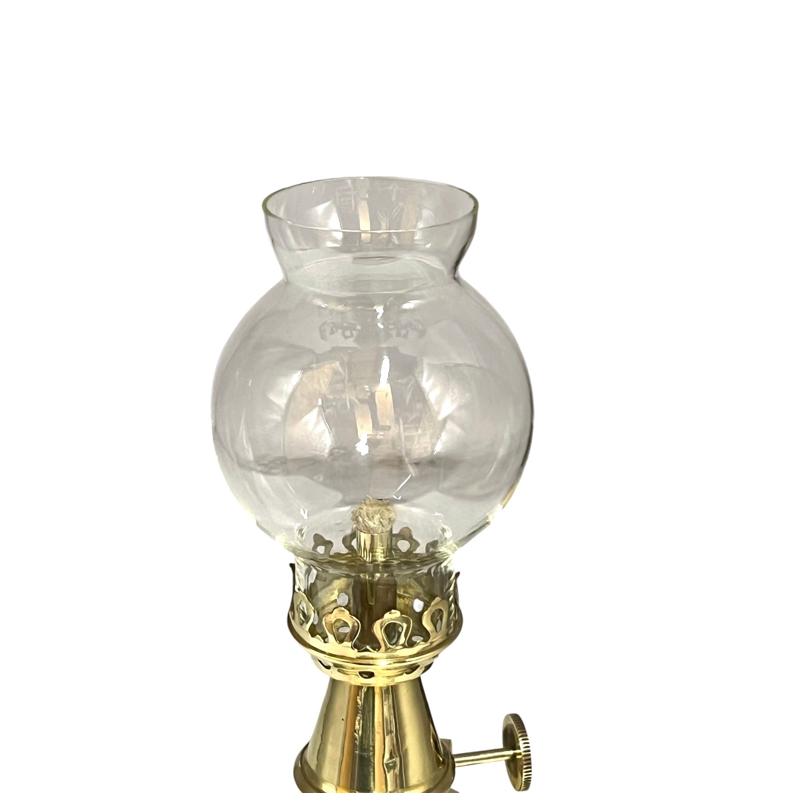 Vintage-style oil lamp with clear glass shade and brass base on a white background