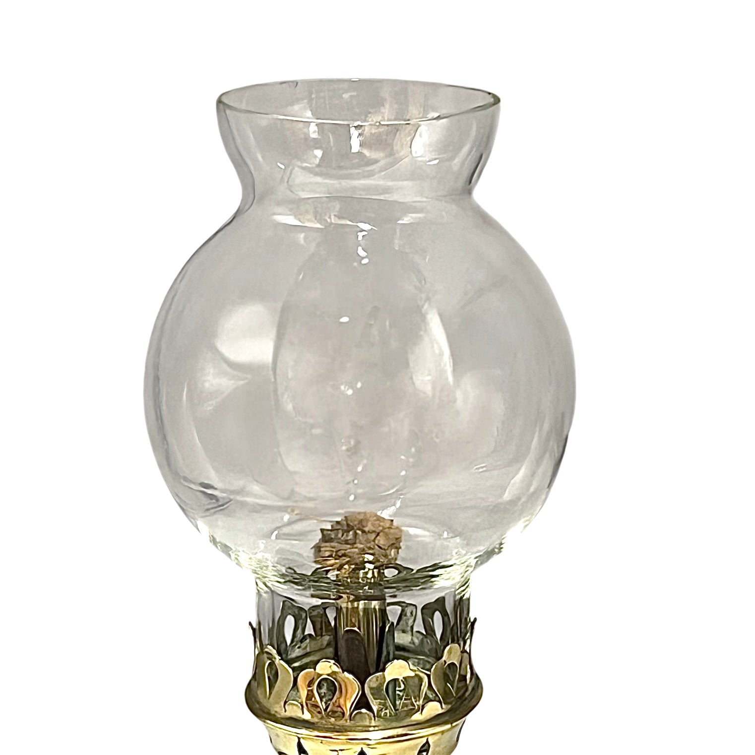 Clear glass oil lamp with decorative base on a white background