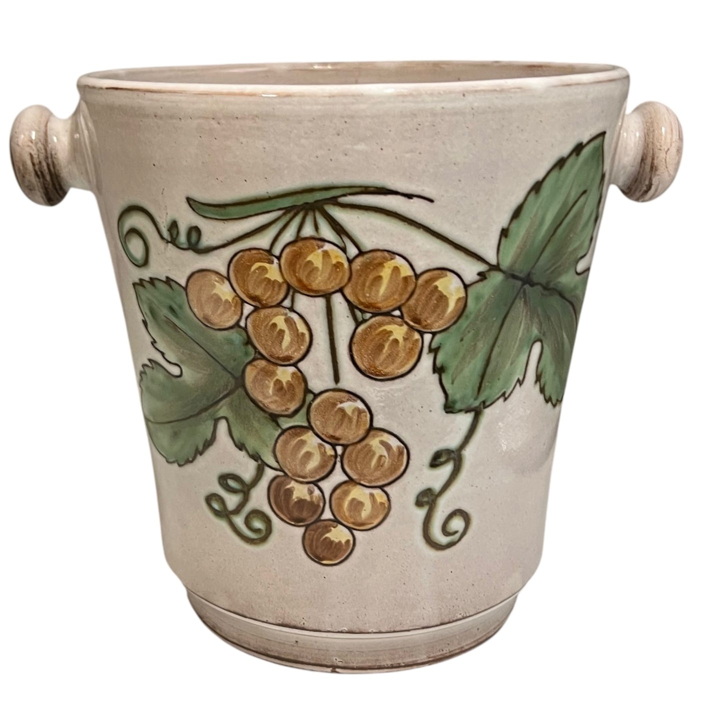 Ceramic glazed ice bucket with grapevine design on a white background