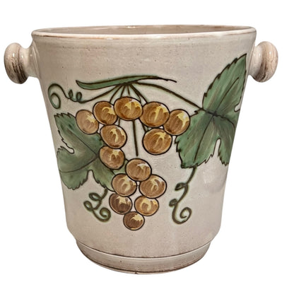 Ceramic glazed ice bucket with grapevine design on a white background