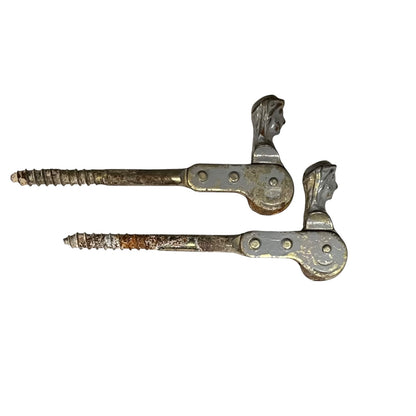 Two rusty metal Belgian ladies shutter dogs on a white background