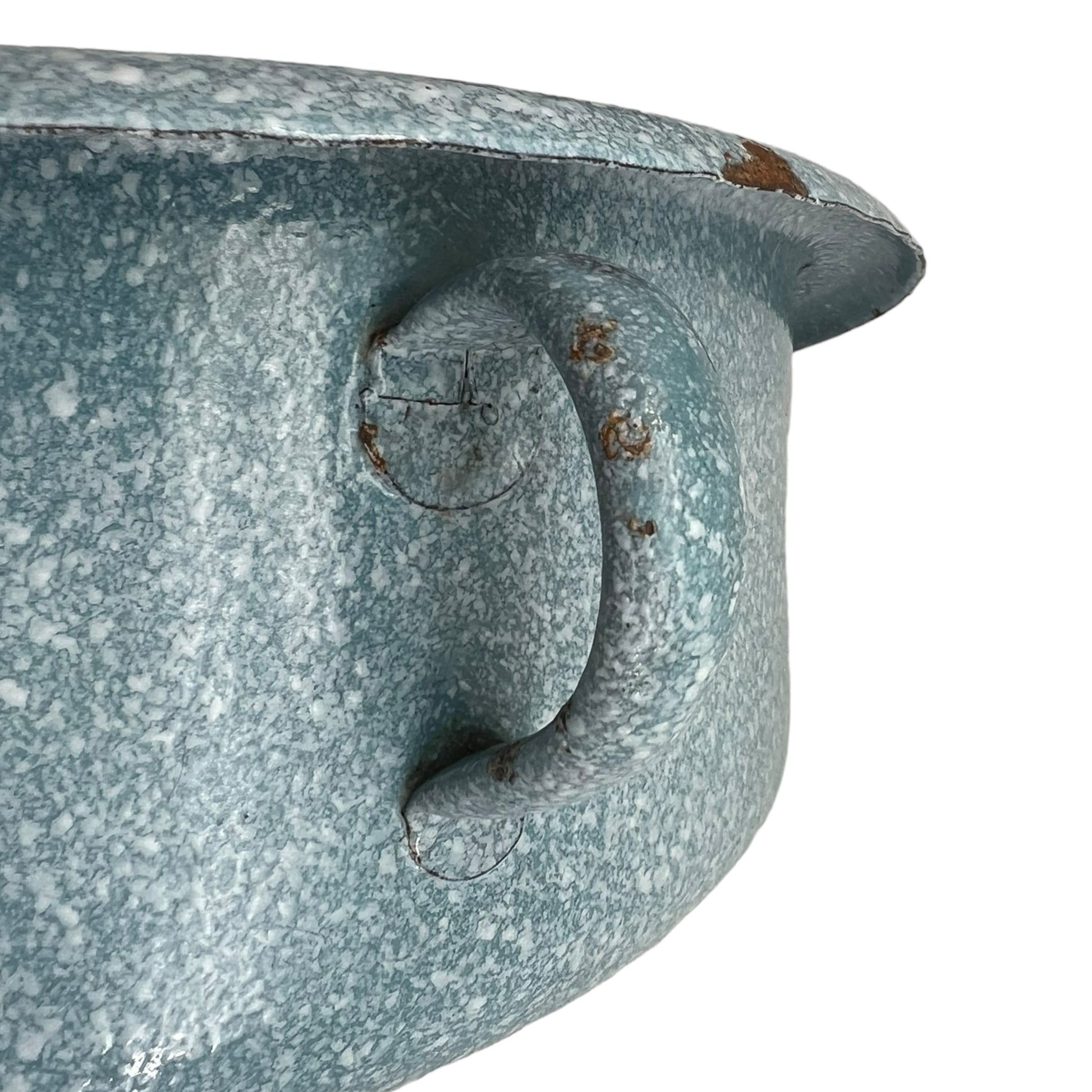 Close-up of wear and tear on a blue metal planter on a white background