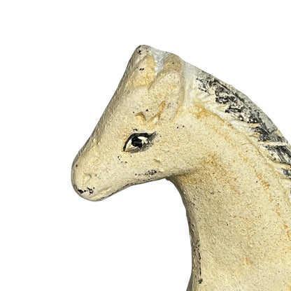 Close-up of a cast iron horse head on a white background