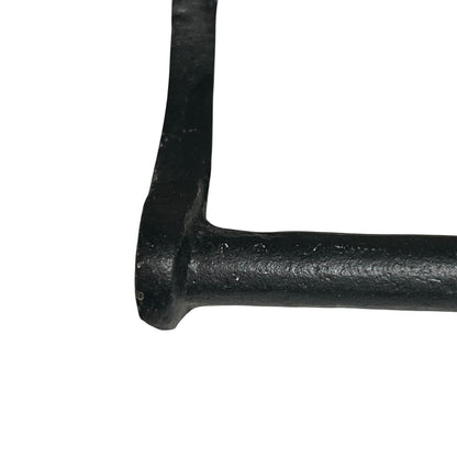 Close-up of a black metal handle on a white background