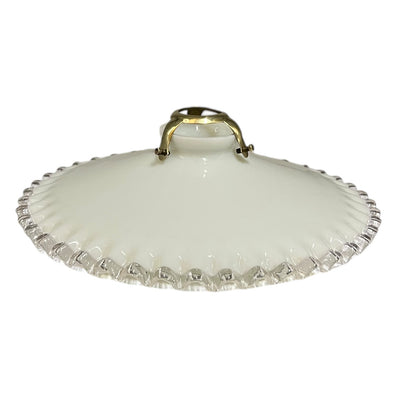 A vintage French milk glass pendant lampshade with a brass gallery holder shown on a white background 