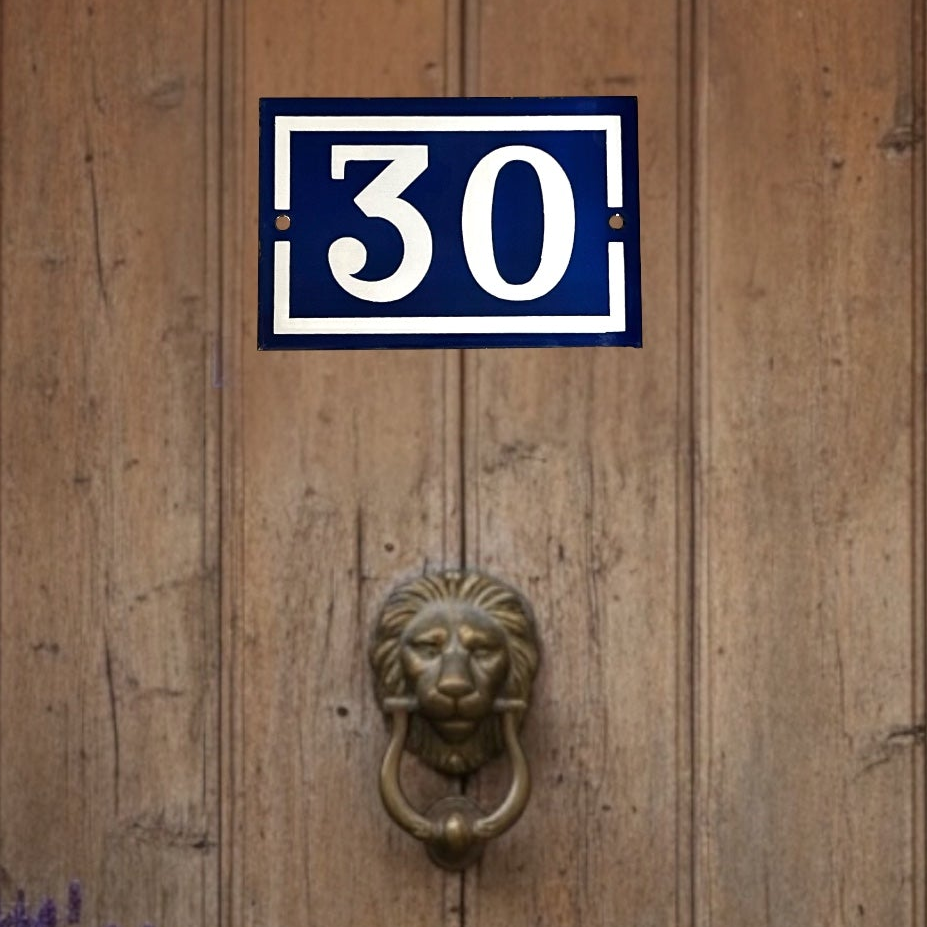 French vintage blue and white door number 30 on a brown wooden door with a lions head knocker