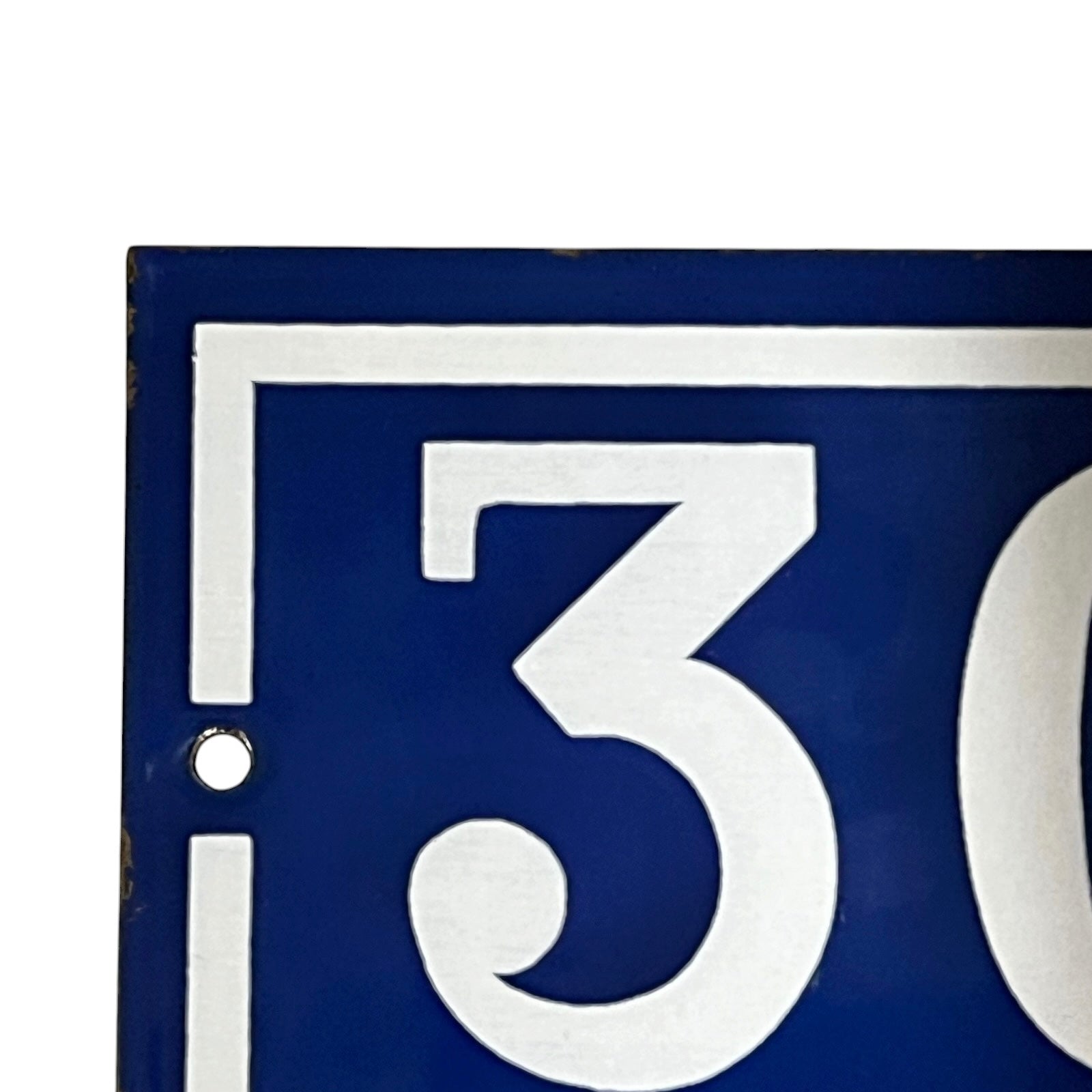 Blue sign with white number '30'