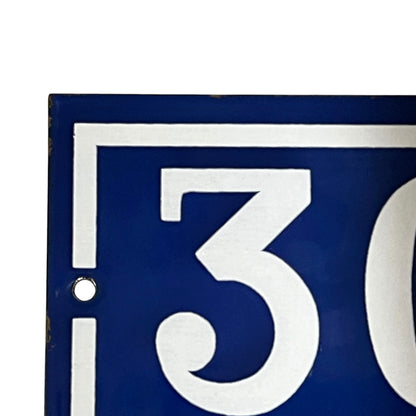 Blue sign with white number '30'