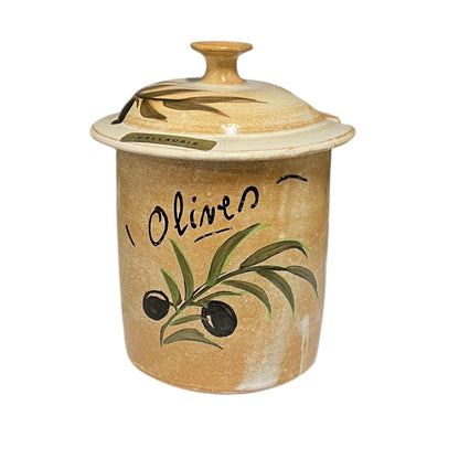 A handmade ceramic canister with a matching lid, decorated with a hand-painted olive branch and the word 'Olives' in black script on a sandy beige background.