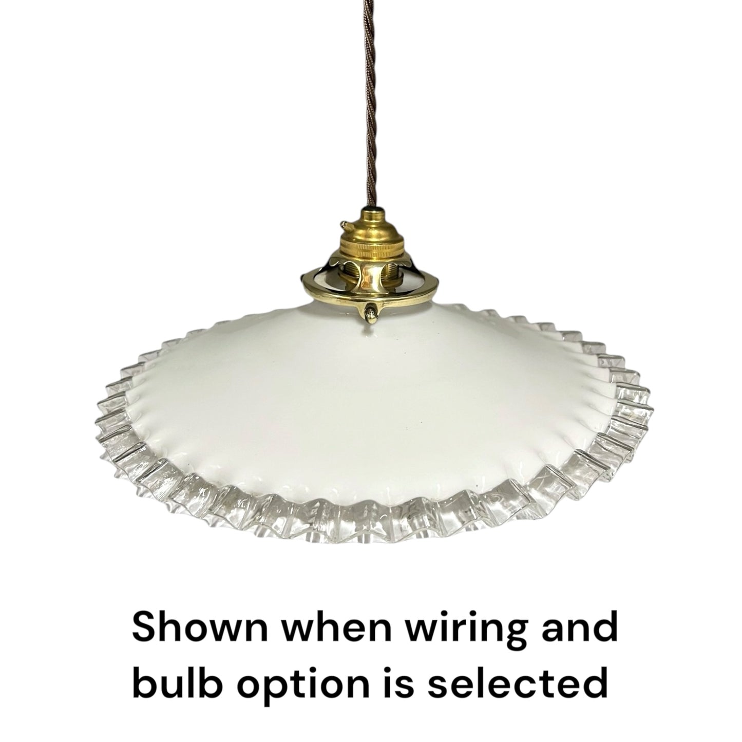A white glass pendant light with a fluted clear glass rim and a brass-colored metal fixture, suspended by a dark cord. Text below reads 'Shown when wiring and bulb option is selected'.