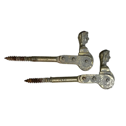 Two rusty metal Belgian ladies shutter dogs on a white background
