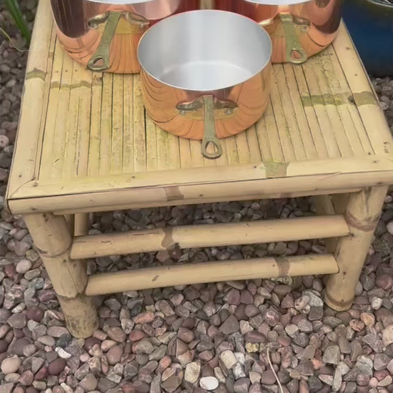 video of copper pan set taken in a garden