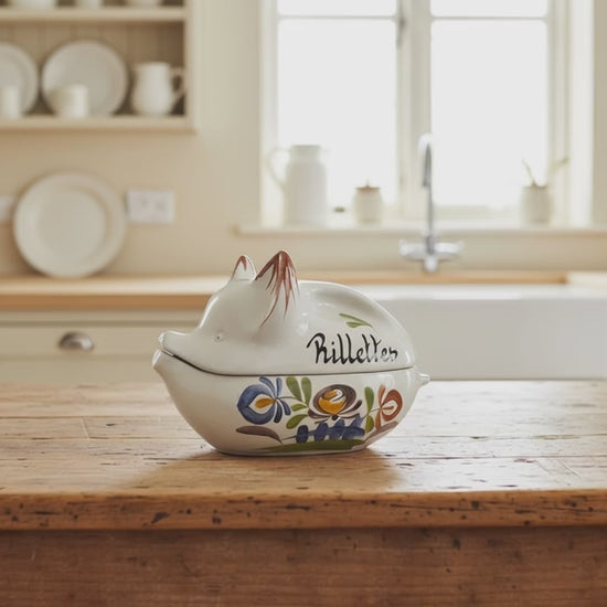 video of small pig shaped rillettes pot on a wooden table 