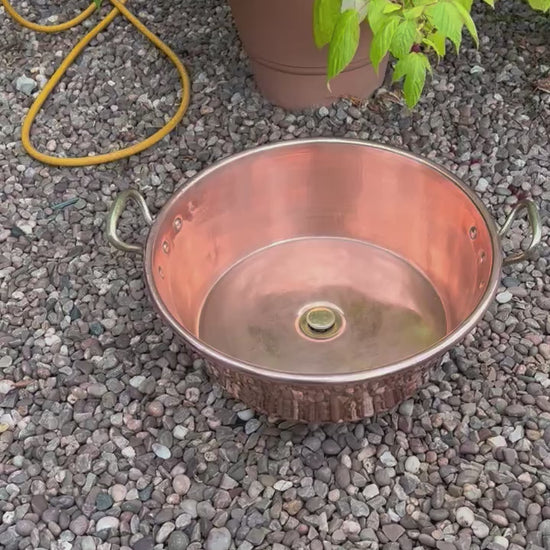 Video of copper sink with brass pop up waste in a garden