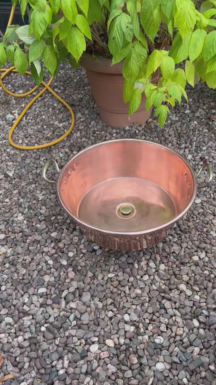Video of copper sink with brass pop up waste in a garden
