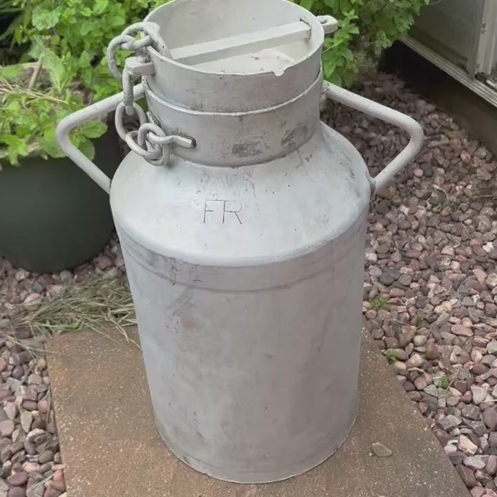 Video of a French vintage aluminim milk churn in a garden setting