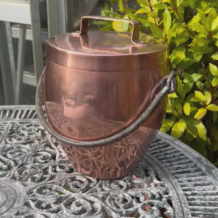 video of a French antique vintage copper stockpot with a wrought iron handle 