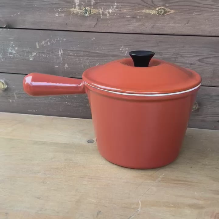 Video of a rust coloured enamelled cast iron saucepan with lid 