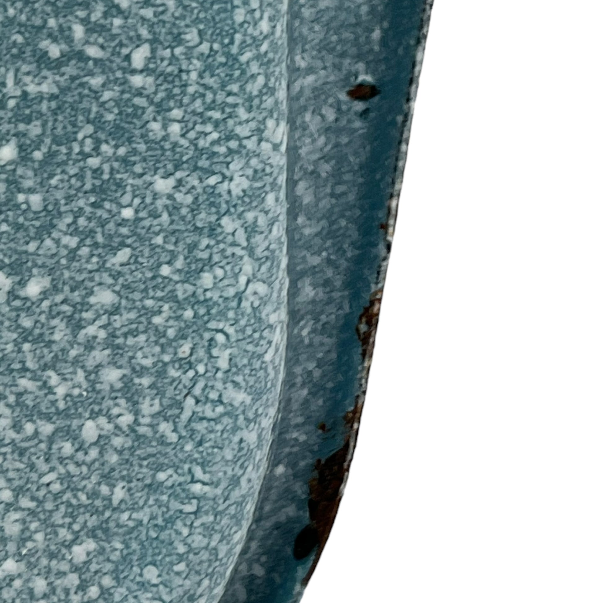 Close-up of wear and tear on a blue metal planter on a white background
