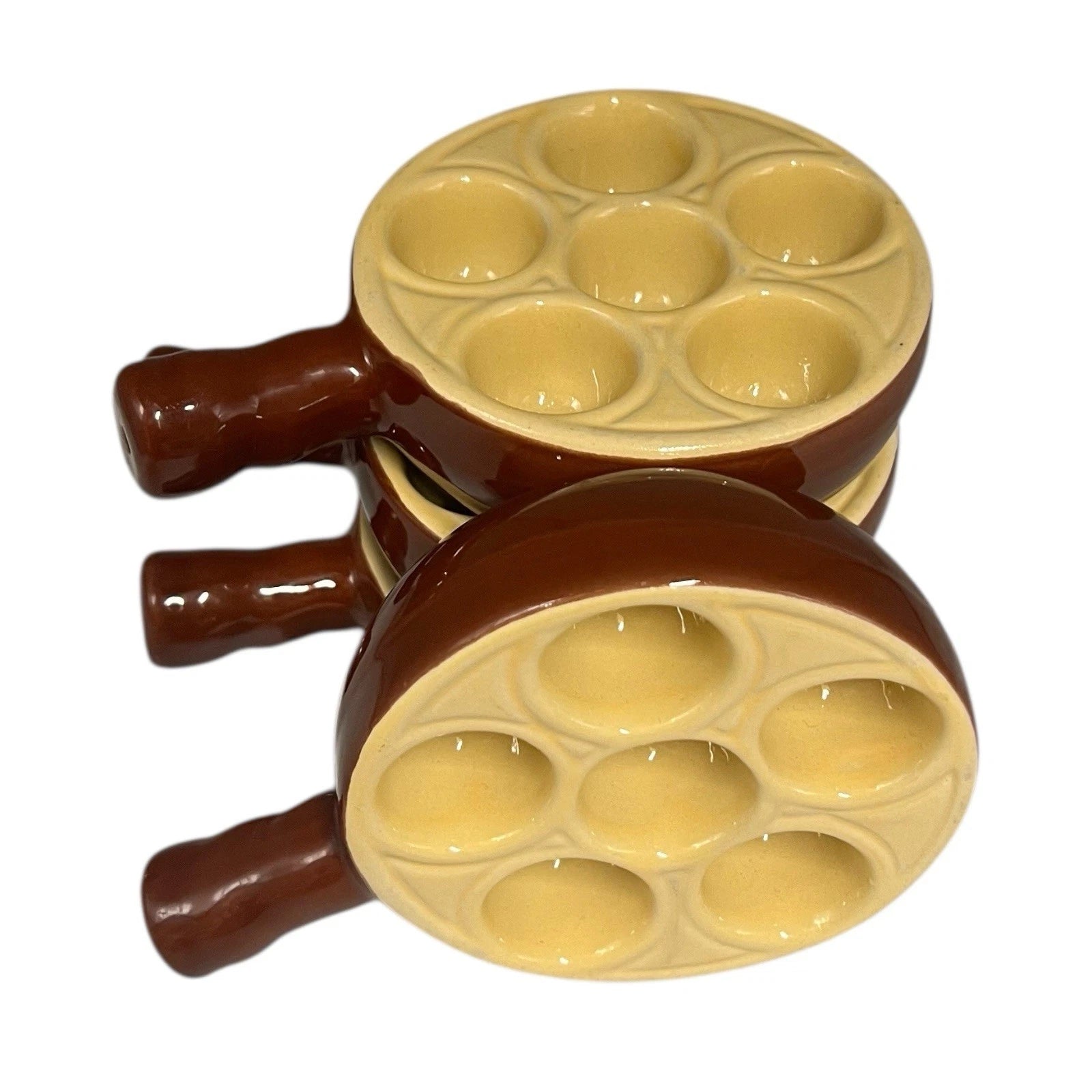 Set of 4 French brown and cream ceramic escargots dishes or plates each with 6 holes, stacked on a white background