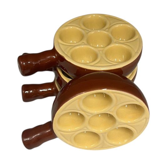 Set of 4 French brown and cream ceramic escargots dishes or plates each with 6 holes, stacked on a white background