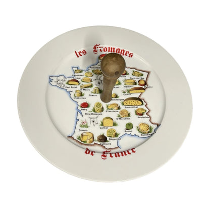 Decorative plate with a map of France featuring regional dishes and a wooden handle.