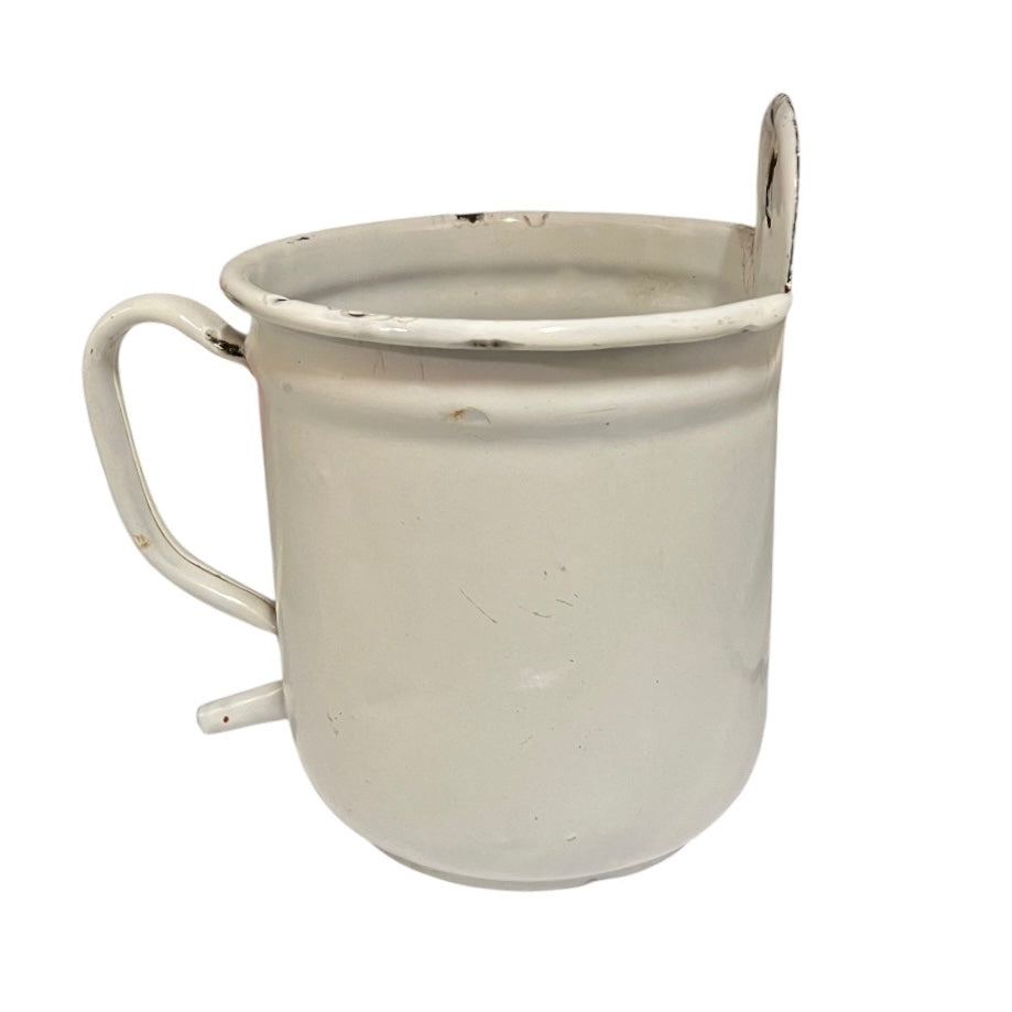 A vintage white enamel metal mug with a handle, a small loop on the rim, and a small protruding tab on the side, shown against a plain white background.