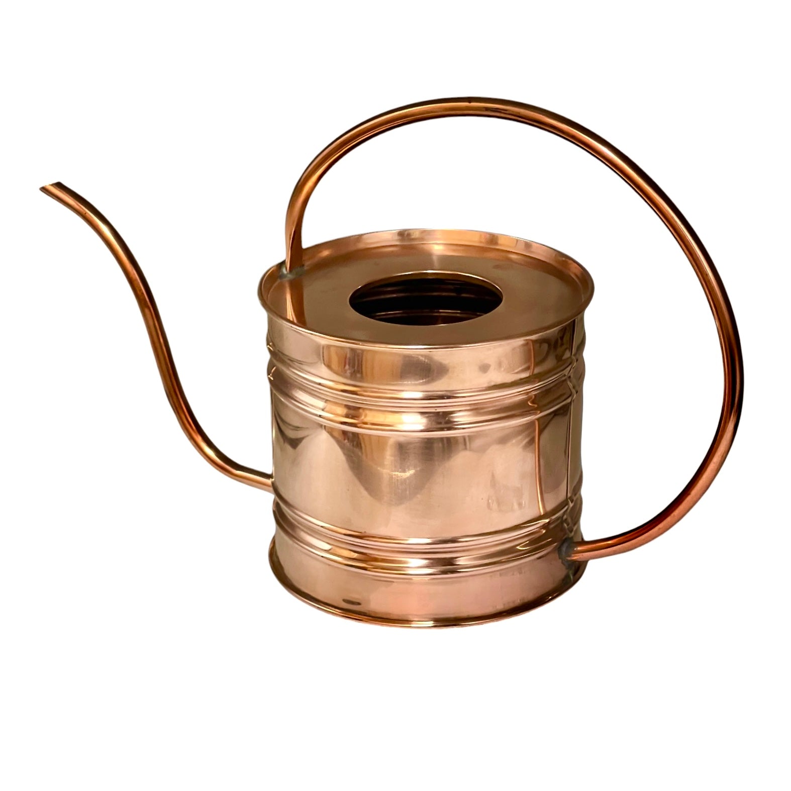 A polished copper watering can with a long spout, curved handle, and ribbed cylindrical body, shown on a plain white background.