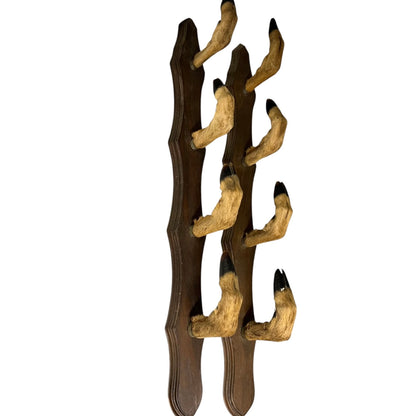 Decorative wall piece with 8 taxidermy deer hooves on a white background