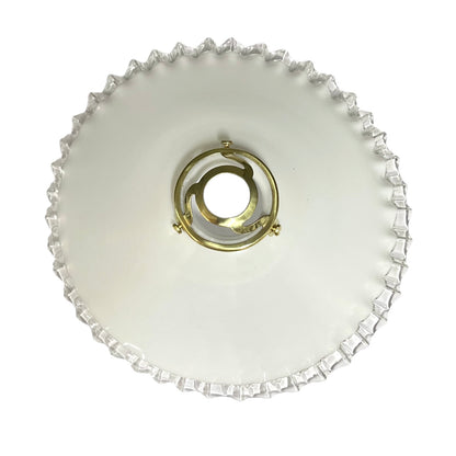 top view of French vintage milk glass pendant lampshade with a brass collar set on a white background 