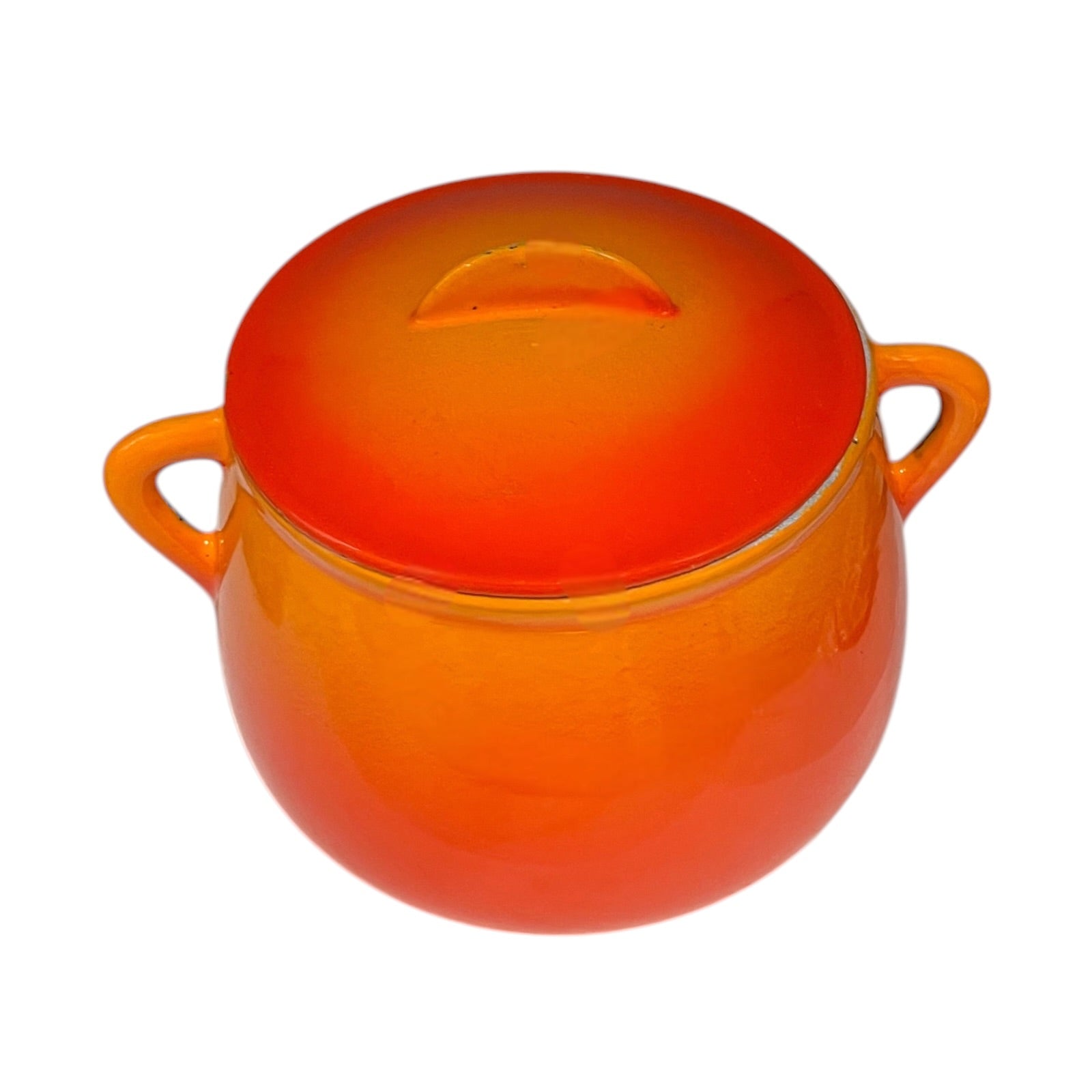 An orange vintage Le Creuset bean pot with two side handles, shown on a plain white background.