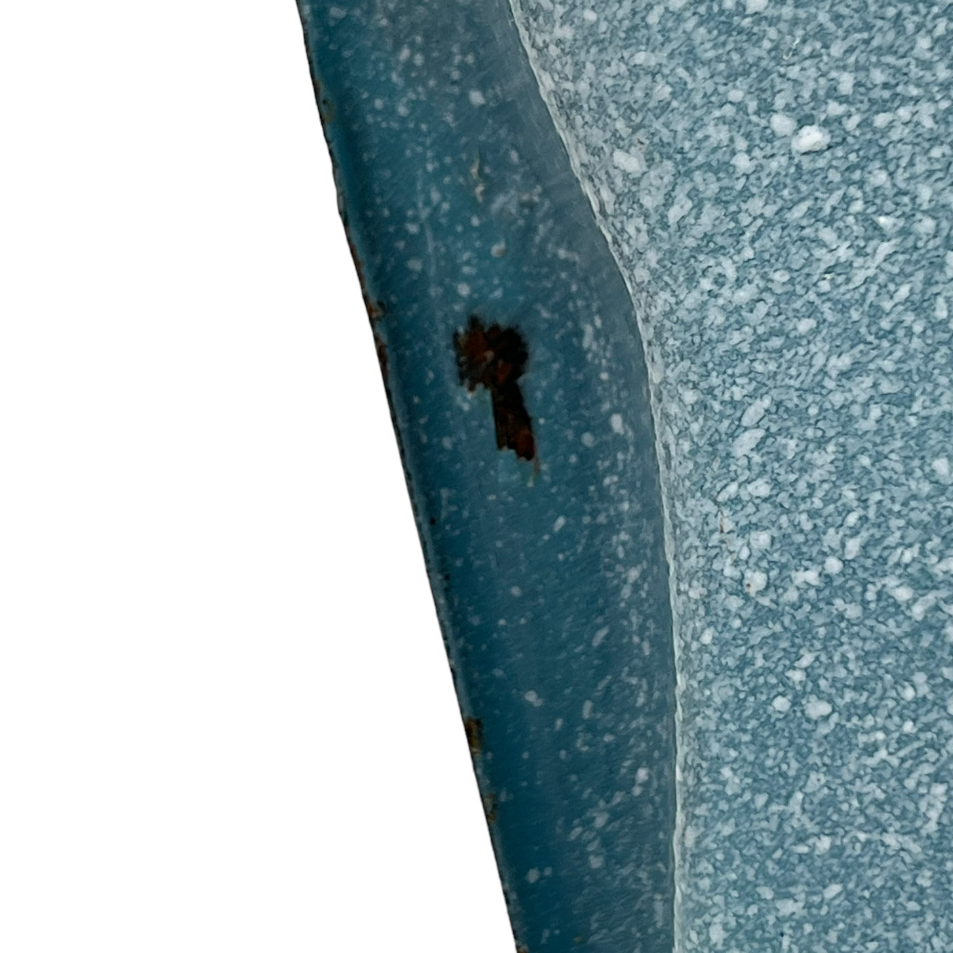 Close-up of wear and tear on a blue metal planter on a white background