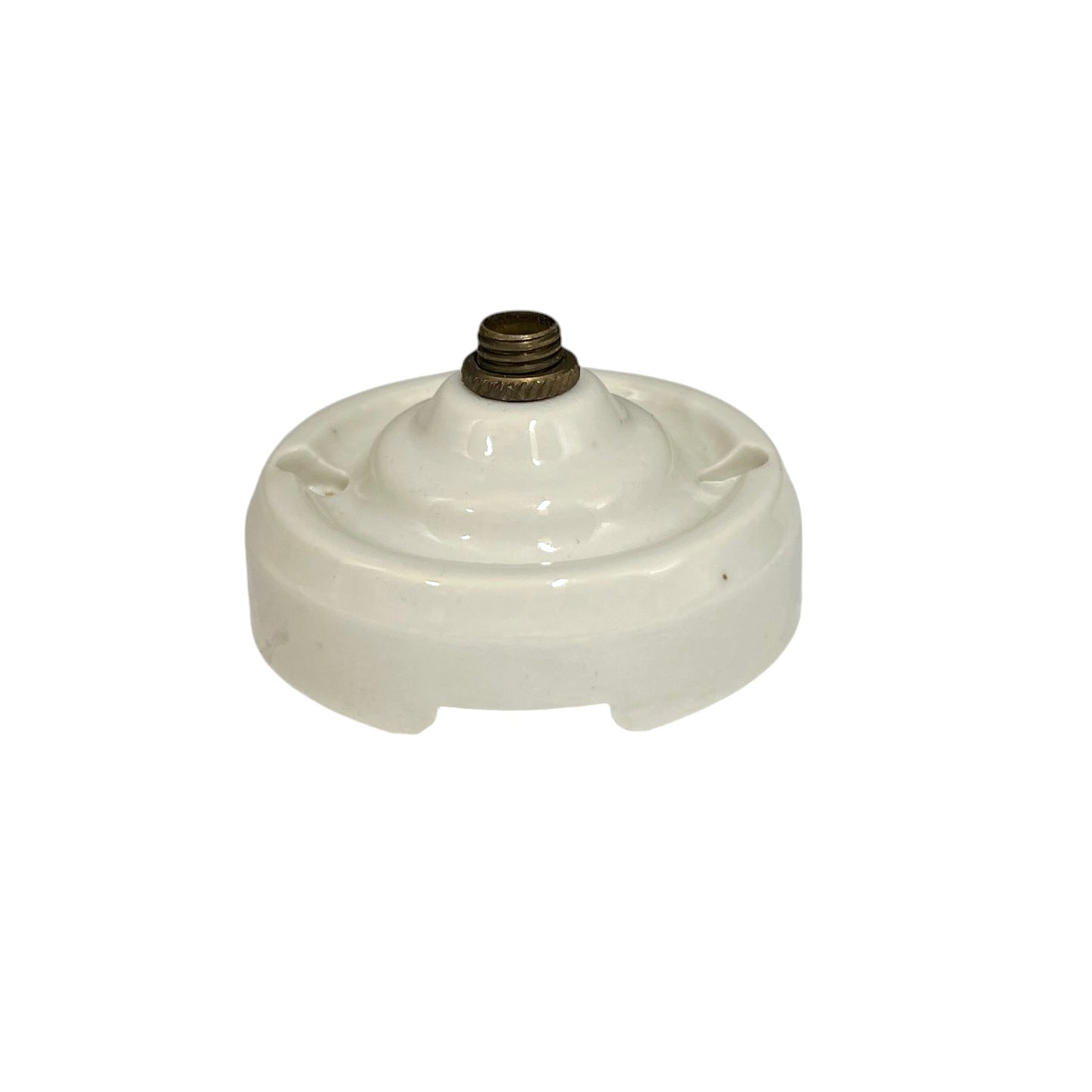 A vintage white porcelain ceiling rose with a brass screw connector on top, isolated on a white background.