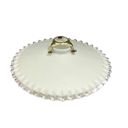A vintage French milk glass pendant lampshade with a brass gallery holder shown on a white background from a top view