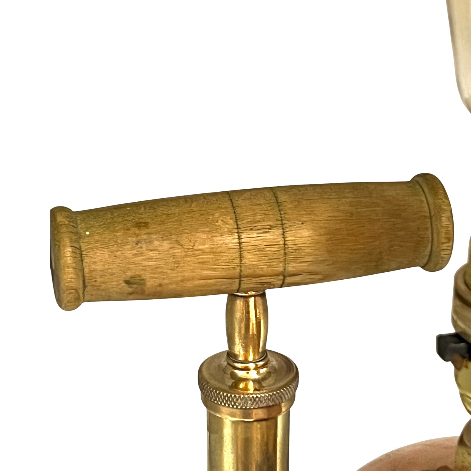 Close-up of a copper and brass lamp with a white background