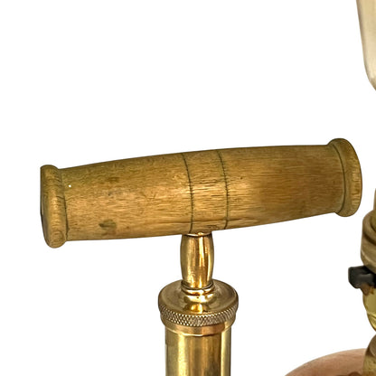 Close-up of a copper and brass lamp with a white background